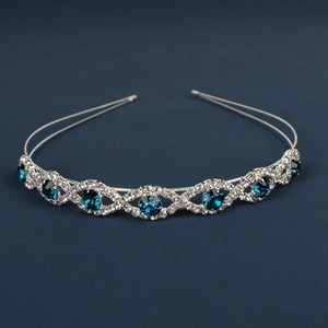Detail of silver wedding tiara with deep blue crystals and small white rhinestones