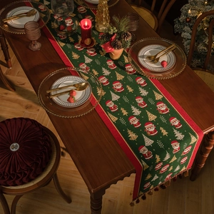 Green Christmas table runner with Santa Claus jacquard patterns and red decorative tassels