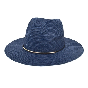 Detail of navy woven straw fedora hat featuring a stylish gold metal decorative band
