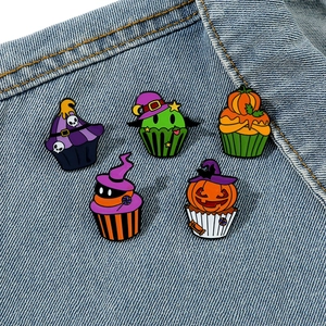 5-piece Halloween cupcake enamel pin set with pumpkins and ghosts on denim jacket