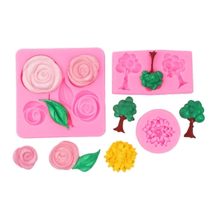 Detail of pink silicone molds for fondant showing rose flower and leaf textures