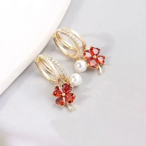 Elegant gold hoop earrings with red heart clover charms and white pearl pendants
