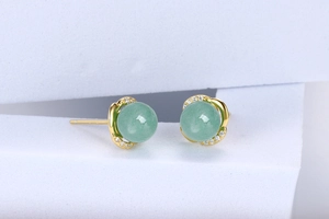 Detail of round green gemstone earrings with sparkling pave-set white zircons