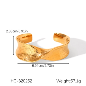 Detail view of 18K gold plated wide open bangle with wavy texture and dimensions
