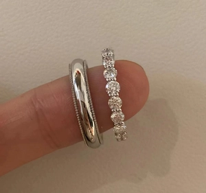 Detailed shot of two stacked S925 silver rings with full eternity zircon stones