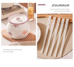 Detailed underglaze flower pattern on purple ceramic tableware set with golden accents