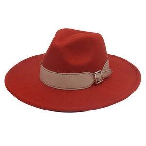 Close-up of wide-brimmed red fedora hat featuring a beige leather belt with silver buckle