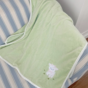 Soft light green lamb fleece bath towel with white braided edges and cute sheep embroidery