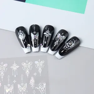 Detail of 3D laser silver butterfly and gothic cross nail art stickers on black tips