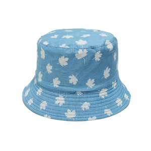 Detail of light blue denim bucket hat featuring white maple leaf print and stitched brim