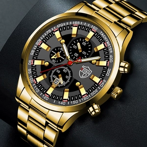 Close-up of gold stainless steel men's watch with black chronograph dial and luminous hands
