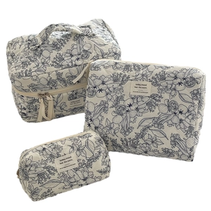Quilted floral makeup bag set including a handle organizer and two storage pouches
