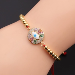 Adjustable red cord bracelet with gold copper beads and colorful zircon evil eye charm