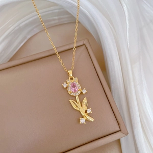 Elegant gold tulip necklace with a pear-shaped pink stone and cubic zirconia accents