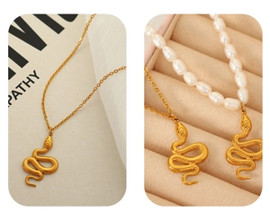 Macro detail of gold snake pendant with natural freshwater pearls and steel chain
