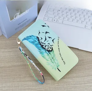 Detail of soft leather wallet with blue feather print and inspirational quote text