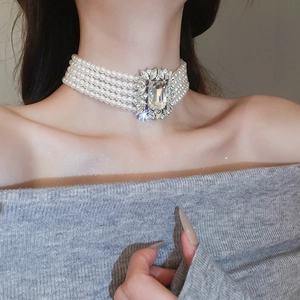 Detail of multi-layer pearl necklace featuring a large square crystal pendant for women