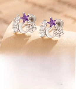 Detailed view of silver snowflake and purple star zircon earrings with screw back studs