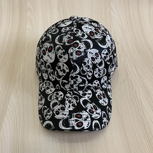 Halloween baseball cap with white skull print and red graffiti accents on black fabric