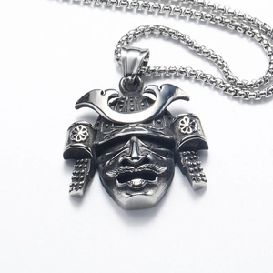 Macro shot of vintage silver Japanese Mempo samurai mask pendant with a round link chain