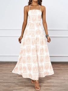 Detail of floral halter neck dress with palm tree print and layered skirt for beach resort