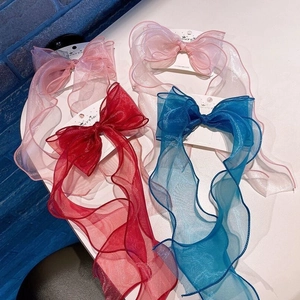 Close-up of colorful long ribbon bow hair clips for girls in tulle material