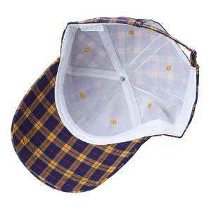 Inside detail of plaid cotton baseball cap showing care label and white lining