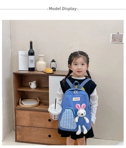 Blue kids backpack with plush bunny accessory and checkered front pocket detail