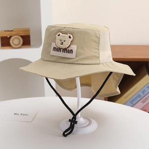 Detail of khaki sun hat featuring breathable mesh, neck flap, and cute bear patch