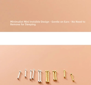 Macro view of tiny S925 sterling silver ball stud earrings in gold and silver finishes
