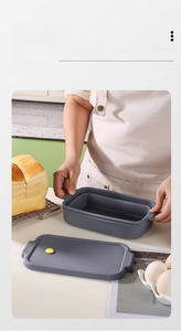 Close-up of foldable silicone bread mold with airtight lid and yellow vent for easy storage