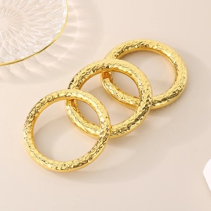 Set of three vintage 18k gold plated stainless steel bangles with hammered texture