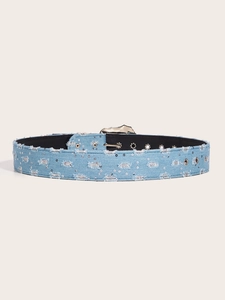 Detailed macro view of light blue denim belt featuring silver sequins and metal eyelets