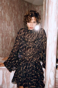 Close-up of floral chiffon dress detailing paisley print and elegant ruffled sleeve cuffs