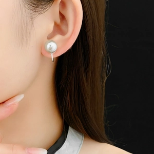 Close-up of model wearing elegant gray pearl ear cuff with silver metal base detail