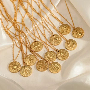 Detailed close-up of 12 zodiac gold coin necklaces with round relief charms on silk