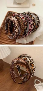 Close-up of leopard print velvet headbands with handmade stamp on inner lining