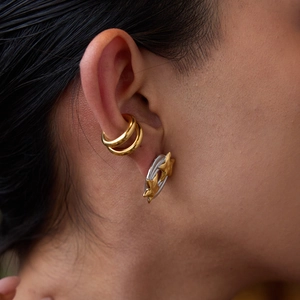 Star earrings and gold ear cuffs in stainless steel shown on a female model