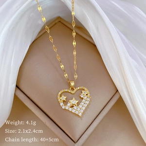 Golden heart necklace with star inlay and dimensions 2.1x2.4cm on a beige background