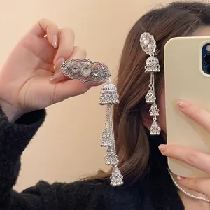 Ethnic vintage silver hair clip with hollow patterns, rhinestones and jhumka tassels