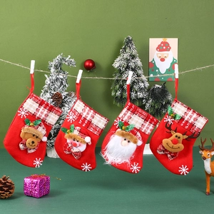 Set of four red Christmas stockings with plush Santa and Reindeer hanging decorations