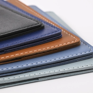 Close-up of stacked PU leather passport covers showing stitched edges and pebbled texture