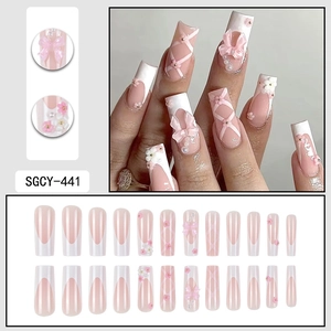 Pink ballet style 3D press-on nails with bow, pearl, and flower decorations in coffin shape