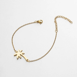 Detailed macro view of golden palm tree pendant bracelet with adjustable lobster clasp