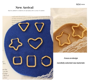 Macro shot of assorted gold-plated titanium earrings in heart and star geometric shapes