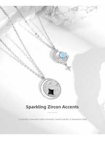 Detail of 925 silver star moon pendants with cubic zirconia inlay on white stone