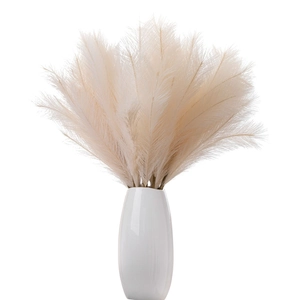 Minimalist beige faux pampas grass decor in a white ceramic vase for home weddings