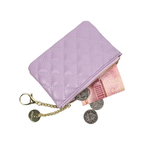 Purple quilted coin purse with gold zipper and chain showing internal cash capacity
