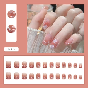 Pink gradient press-on nails with white flower patterns and pearl accents Model Z603