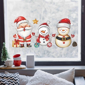 Festive Christmas window stickers with Santa, snowman and stars on a glass surface